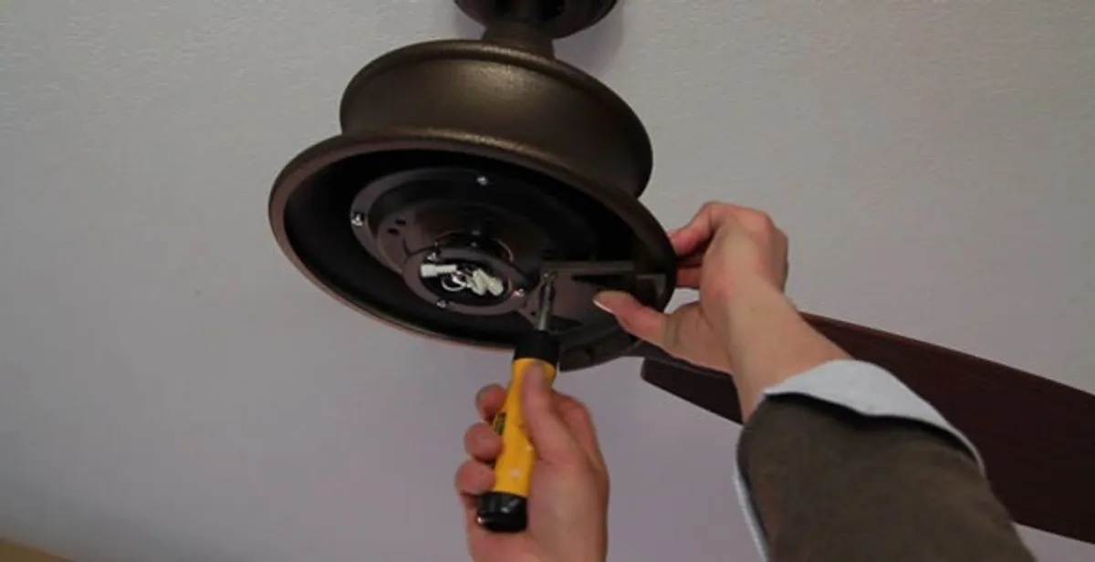Electrician installing ceiling fan mounting bracket and fixture in San Francisco, CA