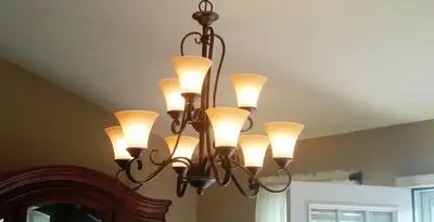 Classic ceiling chandelier installation with warm lighting in San Francisco, CA