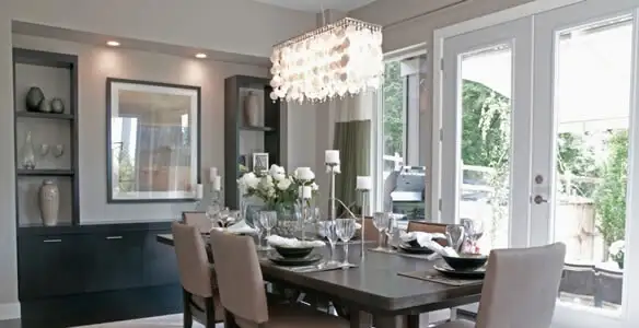 Elegant dining room chandelier installation above table in San Francisco, CA
