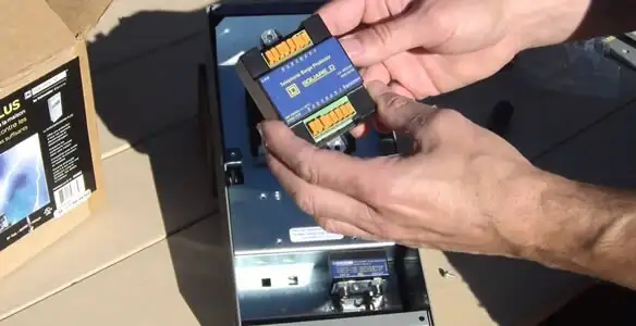 Electrician installing whole home surge protection unit inside main electrical panel in San Francisco, CA
