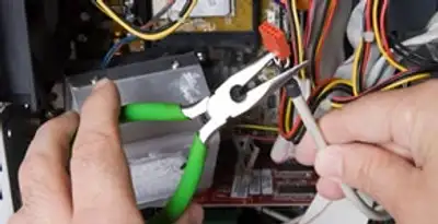 Licensed electrical contractor performing electrical repair with tools in Daly City, CA