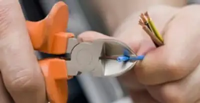 licensed electrician performing precise wire cutting and preparation during electrical service in San Francisco, CA