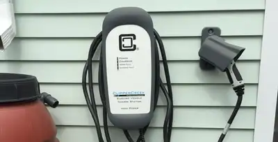 Outdoor electric vehicle charger installation on residential wall in San Francisco, CA