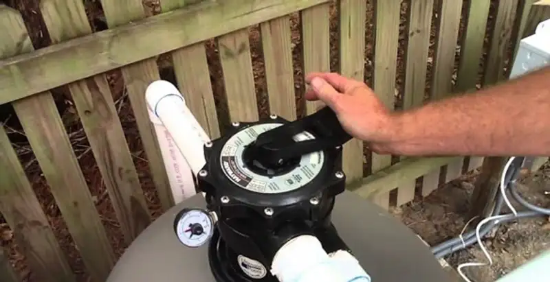 pool pumps service showing professional adjustment of pool pump control system in San Francisco, CA